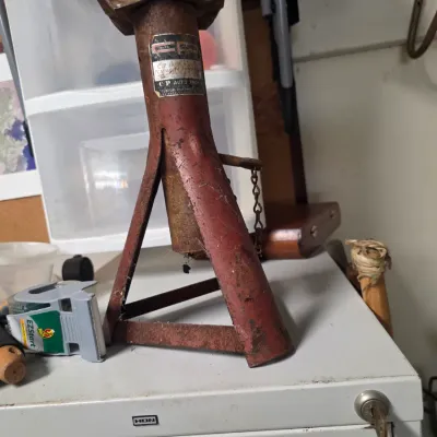 Sale Photo Thumbnail #170: Vintage CP Auto Products heavy-duty jack stand with a red painted finish, showing significant rust and wear from age and use.