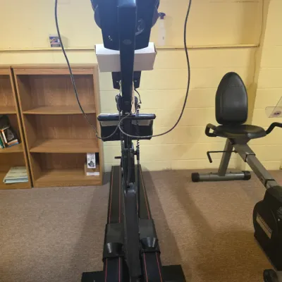 Sale Photo Thumbnail #196: Vintage NordicTrack ski machine, showing some wear from use, positioned next to a Schwinn recumbent exercise bike.