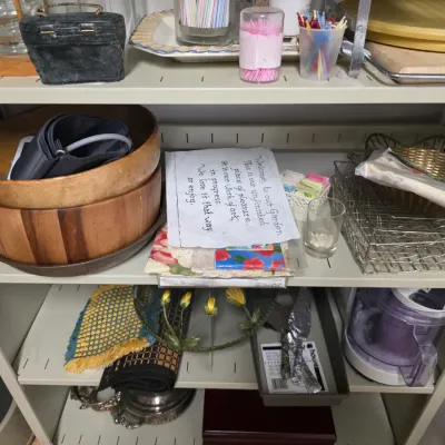 Sale Photo Thumbnail #138: Assorted household items on metal shelving, including wooden salad bowls, wire baskets, a food processor, and various kitchen accessories.