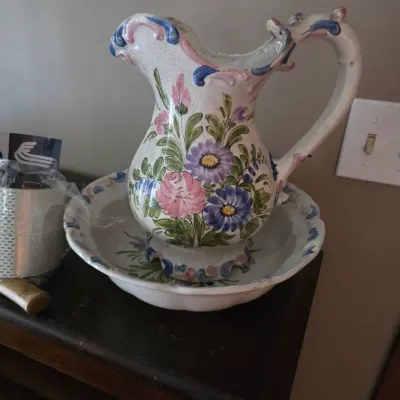 Sale Photo Thumbnail #153: Vintage hand-painted ceramic pitcher and basin set, featuring colorful floral motifs and a crazed glaze finish.
