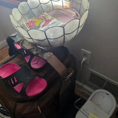 Sale Photo Thumbnail #112: Vintage capiz shell scalloped bowl with leaded trim, shown holding miscellaneous items alongside a pair of pink and black sandals on a textured trunk.