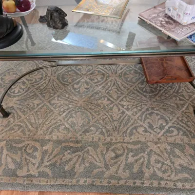 Sale Photo Thumbnail #61: Large area rug featuring a muted sage green and beige damask pattern with a thick decorative border, shown beneath a glass-top coffee table.