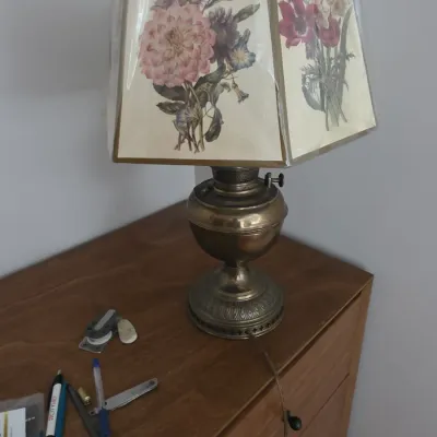 Sale Photo Thumbnail #94: Vintage brass hurricane-style electric table lamp featuring a hexagonal shade adorned with botanical floral illustrations.
