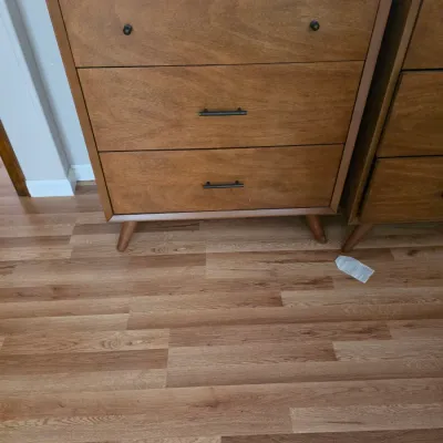 Sale Photo Thumbnail #92: Mid-century modern style three-drawer wooden chest with tapered legs and mismatched hardware, showing some light wear.