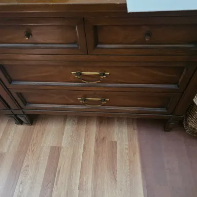 Sale Photo Thumbnail #108: Vintage wooden dresser featuring two small top drawers with round knobs and two larger bottom drawers with brass bail handles.
