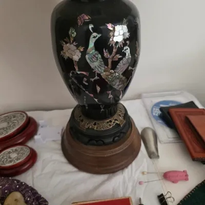 Sale Photo Thumbnail #124: Vintage Asian black lacquer table lamp featuring mother-of-pearl inlay depicting peacocks and floral motifs, mounted on a wooden base.
