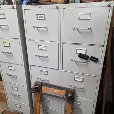 Sale Photo Thumbnail #169: Three vintage gray metal four-drawer filing cabinets with silver-tone handles and label holders, showing some wear from use.
