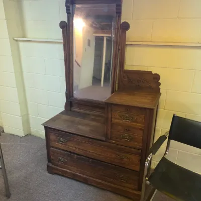 Sale Photo Thumbnail #186: Antique Eastlake-style oak dressing table featuring a tall swivel mirror, carved details, and brass hardware, circa late 19th century.