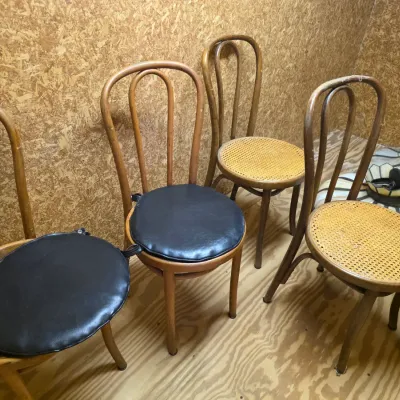 Sale Photo Thumbnail #204: Set of four vintage bentwood chairs, two featuring woven cane seats and two with black vinyl seat cushions.