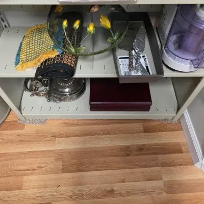 Sale Photo Thumbnail #139: Assorted kitchenware and household items on a metal shelving unit, including a food processor, a decorative metal basket, and a wooden storage box.