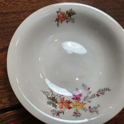 Sale Photo Thumbnail #29: Vintage ceramic serving bowl featuring a colorful autumn leaf motif on a white background.