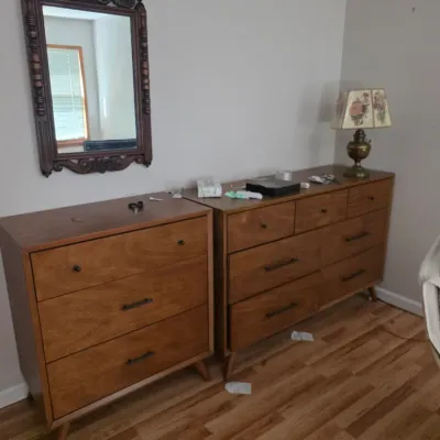Sale Photo Thumbnail #91: Mid-century modern style bedroom set featuring a three-drawer chest and a six-drawer double dresser, both in a warm wood finish with tapered legs.
