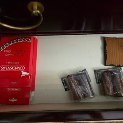 Sale Photo Thumbnail #20: Connoisseurs silver jewelry polishing cloth boxes alongside small wooden decorative items and packaged tassels inside a drawer.