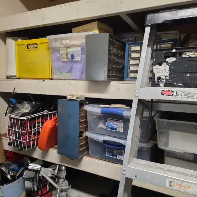 Sale Photo Thumbnail #172: Assorted garage storage items including plastic bins, metal organizer drawers, a wire basket, and a Keller aluminum stepladder.
