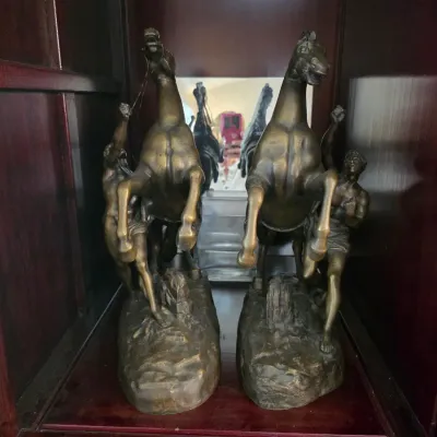 Sale Photo Thumbnail #14: Pair of vintage bronze-finished bookends depicting the Marly Horses, featuring rearing horses with handlers on rocky bases.
