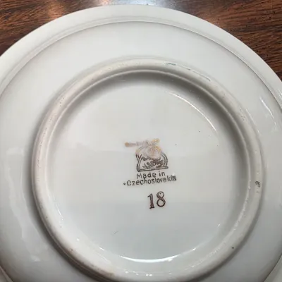 Sale Photo Thumbnail #30: Underside of a vintage white porcelain saucer showing a "Made in Czechoslovakia" maker's mark and the number 18.