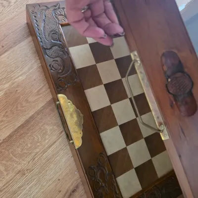 Sale Photo Thumbnail #71: Vintage hand-carved wooden chessboard box with brass hardware and ornate dragon details along the border.
