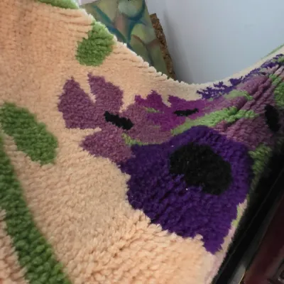 Sale Photo Thumbnail #47: Vintage latch hook rug featuring a vibrant purple floral design on a beige background with green accents.