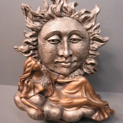 Sale Photo Thumbnail #13: Celestial-themed bronze-finished sculpture featuring a reclining woman on a cloud looking up at a large, stylized sun face.