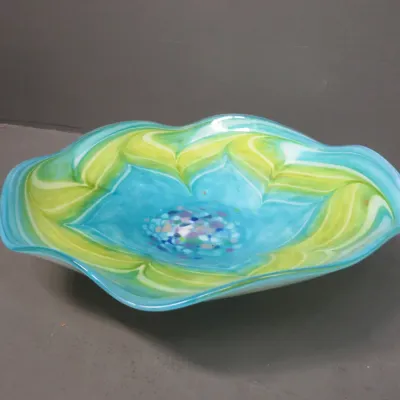 Sale Photo Thumbnail #16: Art glass bowl featuring a wavy rim, vibrant turquoise and lime green swirls, and a speckled center design.