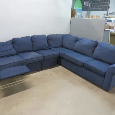 Sale Photo Thumbnail #2: Large blue fabric sectional sofa featuring a corner configuration and a built-in reclining seat on the left end.