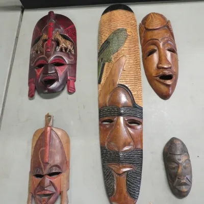 Sale Photo Thumbnail #26: Collection of five hand-carved wooden African-style decorative wall masks in various sizes and finishes.
