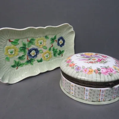 Sale Photo Thumbnail #11: Vintage porcelain vanity set featuring a rectangular majolica-style floral tray and a matching oval hinged trinket box with floral motifs.