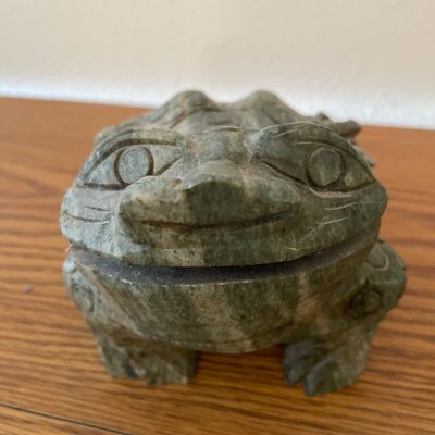 Sale Photo Thumbnail #54: A hand-carved decorative frog figurine crafted from a green stone, possibly soapstone or jadeite.