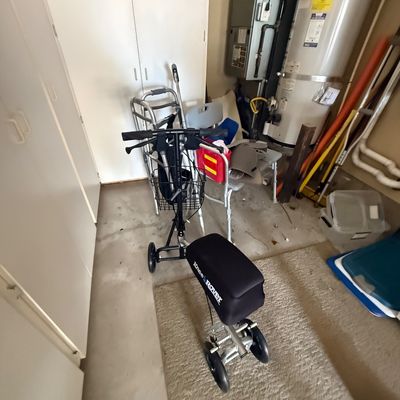 KneeRover steerable knee scooter with a black padded seat and front wire basket, shown alongside other mobility aids including a standard...
