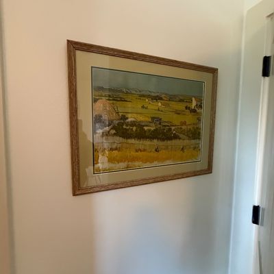 Framed print of Vincent van Gogh's "The Harvest," presented under glass with a neutral mat and a simple wood-grain frame.