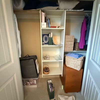 White laminate closet shelving unit and a two-drawer wooden filing cabinet, shown with various storage baskets and household items.