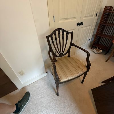 Hepplewhite-style shield-back armchair with carved mahogany frame and striped fabric seat cushion.