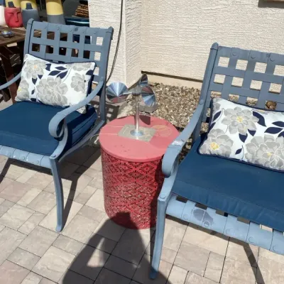 Two Metal Lawn Chairs, Table, and Decor