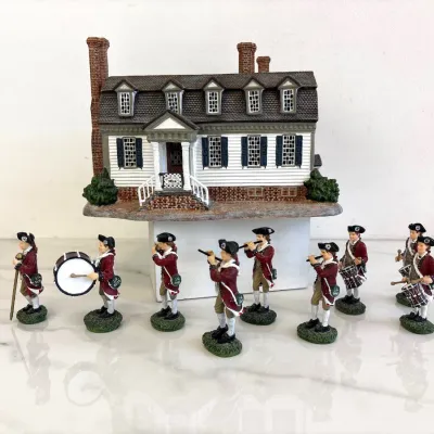 Sale Photo Thumbnail #56: Williamsburg colonial house figurine paired with a set of eight hand-painted revolutionary war fife and drum corps soldier figurines.