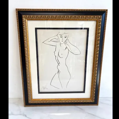 Sale Photo Thumbnail #51: Framed Henri Matisse lithograph print featuring a minimalist line drawing of a female nude, presented in an ornate gold and black wooden frame with double matting.