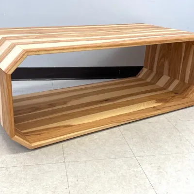 Sale Photo Thumbnail #463: Modernist octagonal loop coffee table crafted from laminated mixed hardwoods, featuring a hollow geometric design with prominent wood grain striping.