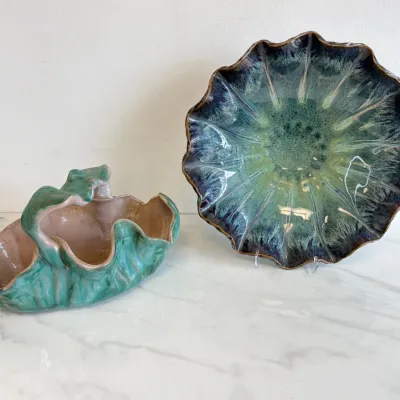 Sale Photo Thumbnail #159: Vintage Hull pottery art deco double cornucopia vase in green and pink, alongside a mid-century drip glaze ceramic fluted bowl in shades of green and blue.