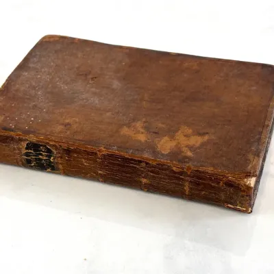 Sale Photo Thumbnail #197: Antique leather-bound book featuring a heavily worn, distressed brown cover and spine, showing significant age and patina.