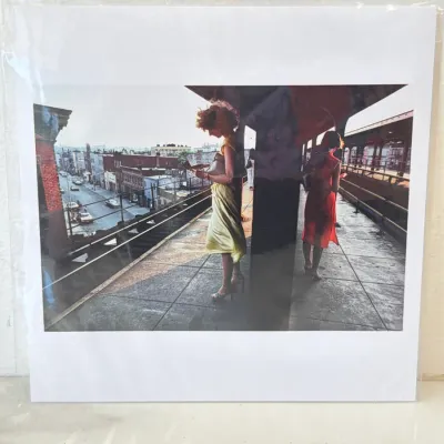 Sale Photo Thumbnail #281: Matted color art print of Helen Levitt's iconic photograph "New York (Two Women on El Platform), 1980," depicting two women waiting on an elevated subway platform, sealed in protective plastic.