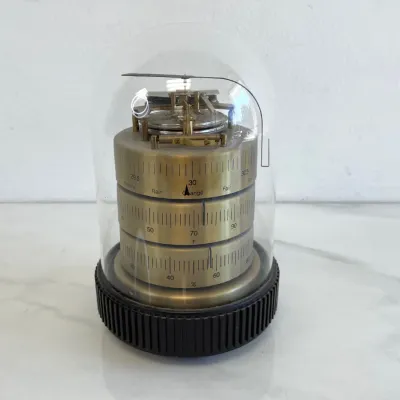 Sale Photo Thumbnail #114: Vintage Airguide weather station featuring a brass barometer, thermometer, and hygrometer housed under a clear glass dome with a black ribbed base.