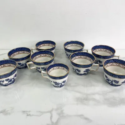 Sale Photo Thumbnail #383: Set of nine vintage Booths Real Old Willow pattern teacups, featuring classic blue and white transferware with gold-gilt rims.