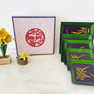 Sale Photo Thumbnail #262: Vintage Korean Hanji paper craft set featuring a decorative storage box with a red cut-out medallion and five matching square nesting trays in purple and green with yellow floral motifs.