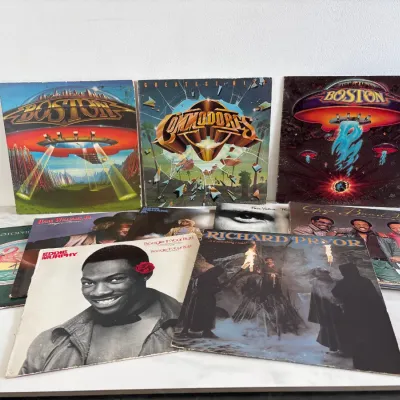 Sale Photo Thumbnail #9: Lot 8654 Collection of vintage vinyl LP records featuring classic rock, funk, and comedy artists including Boston, Commodores, Eddie Murphy, Richard Pryor, and The Gap Band.