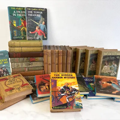 Sale Photo Thumbnail #201: Collection of vintage children's adventure books, featuring several Grosset & Dunlap editions of The Hardy Boys by Franklin W. Dixon, Tom Swift by Victor Appleton, and The Bobbsey Twins series.