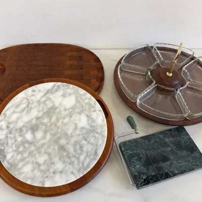 Sale Photo Thumbnail #62: Mid-century modern Dansk teak wood serving pieces, including a round marble cheese board, an oval end-grain cutting board, a lazy Susan with glass insert dishes, and a green marble wire cheese slicer.