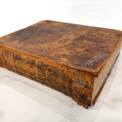 Sale Photo Thumbnail #206: Antique leather-bound book featuring a heavily distressed, weathered brown cover and spine with significant wear and patina.