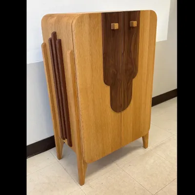 Sale Photo Thumbnail #464: Art Deco style two-tone oak and walnut bar cabinet, featuring rounded corners, geometric wood accents, and square pulls.