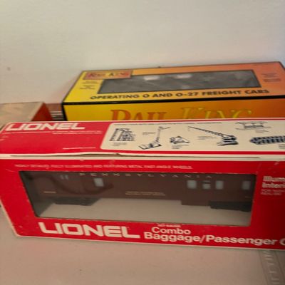 Lionel O27 gauge Pennsylvania Combo Baggage/Passenger Car in its original red box, shown alongside a Rail King freight car box.