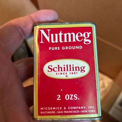 Vintage Schilling 2-ounce pure ground nutmeg tin, featuring the classic red, white, and yellow branding from McCormick & Company.