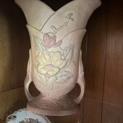 Vintage Roseville pottery Magnolia vase in dusty pink and blue tones, featuring a flared rim, double handles, and raised floral motif.